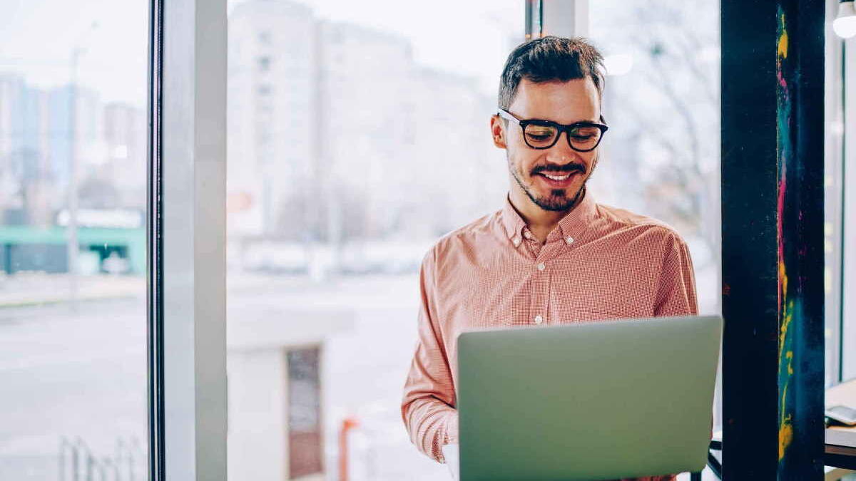 Man standing up looking at a computer