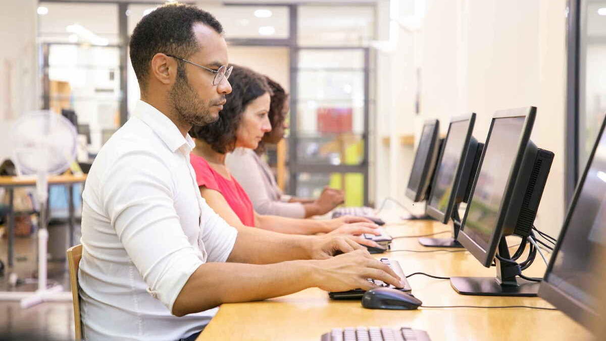 Man and women taking an assessment on computers