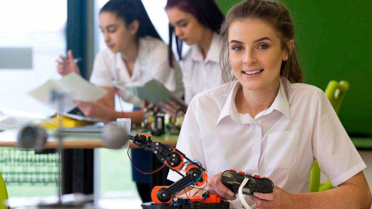 Girl science students building a robot