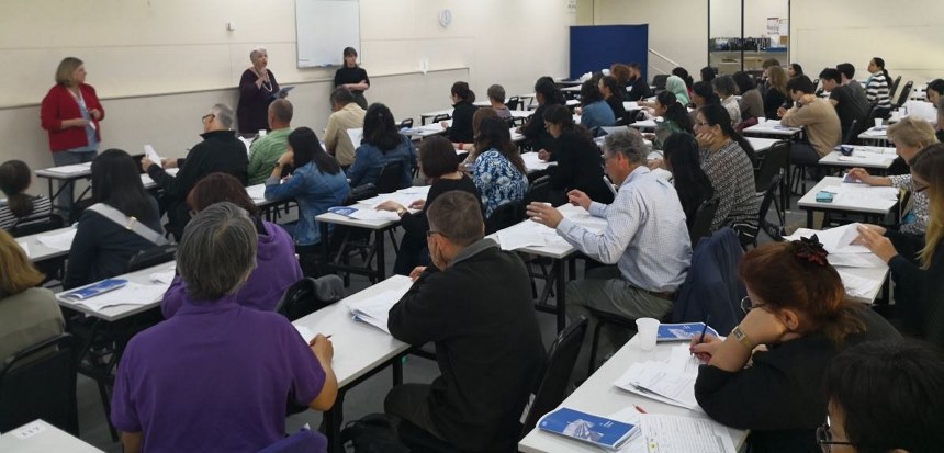 Photo of a pen and paper exam room with candidates