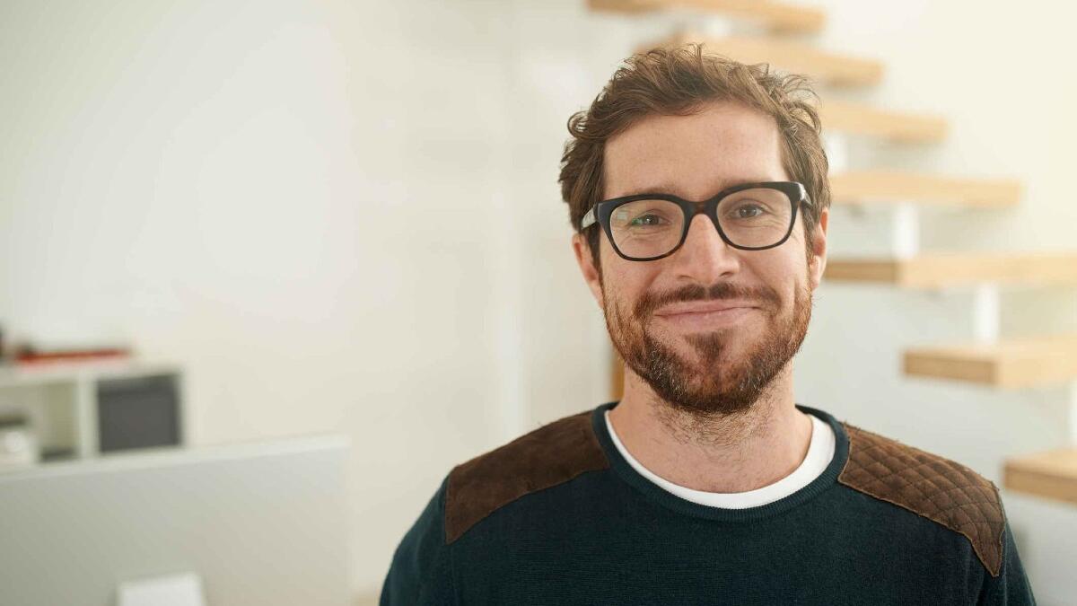 smiling man in glasses