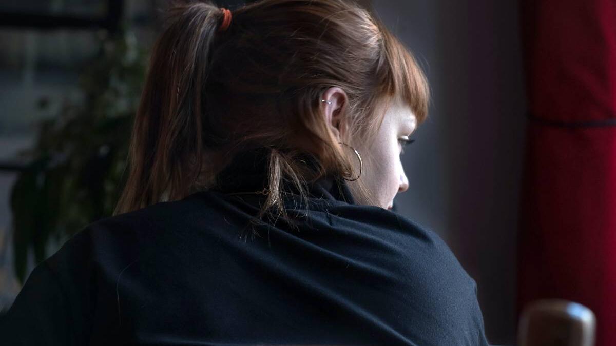 Girl sitting and looking at the window