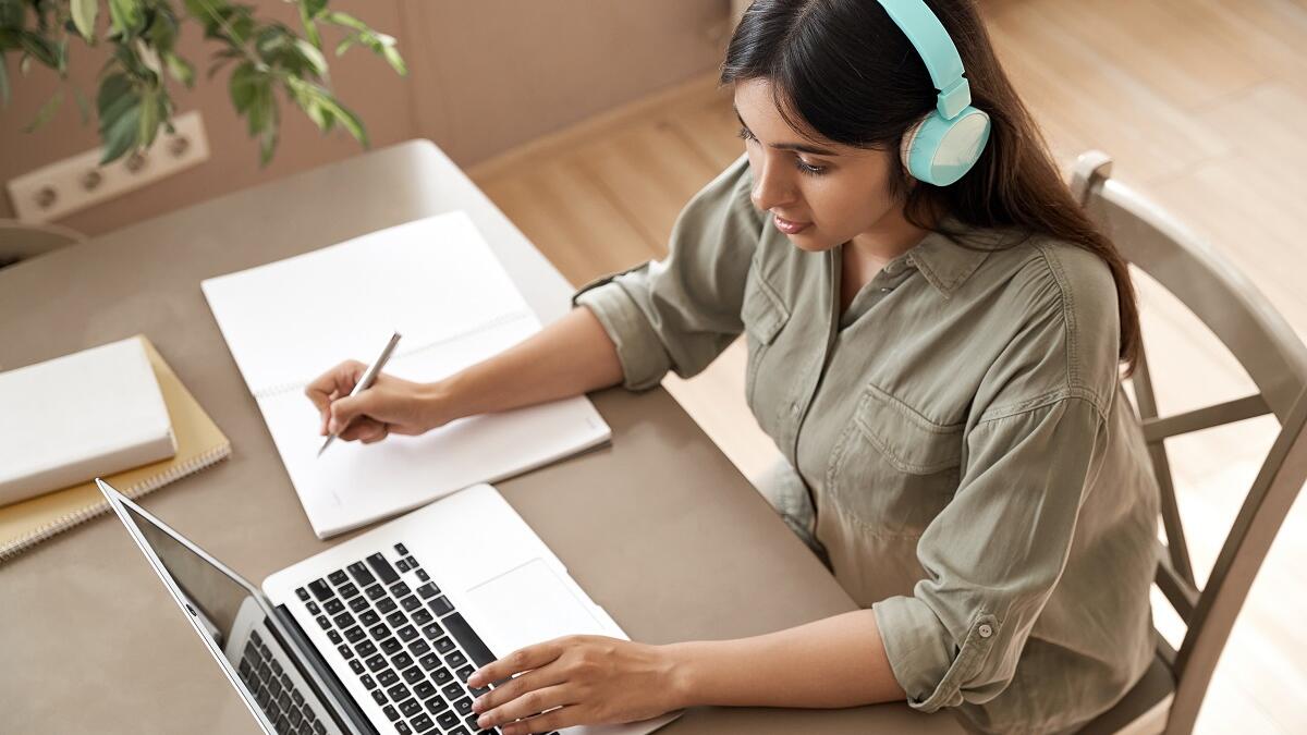 Girl working on computer with headphone