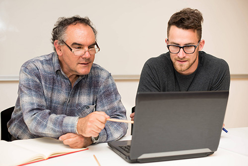 Men working on a computer