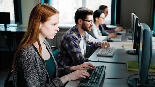 Students taking an online exam on computers