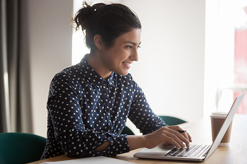 Woman sitting at a desk working on a computer