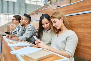 students looking at mobile during lecture