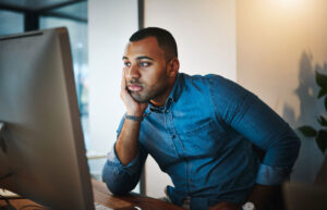 mildly frustrated man on computer